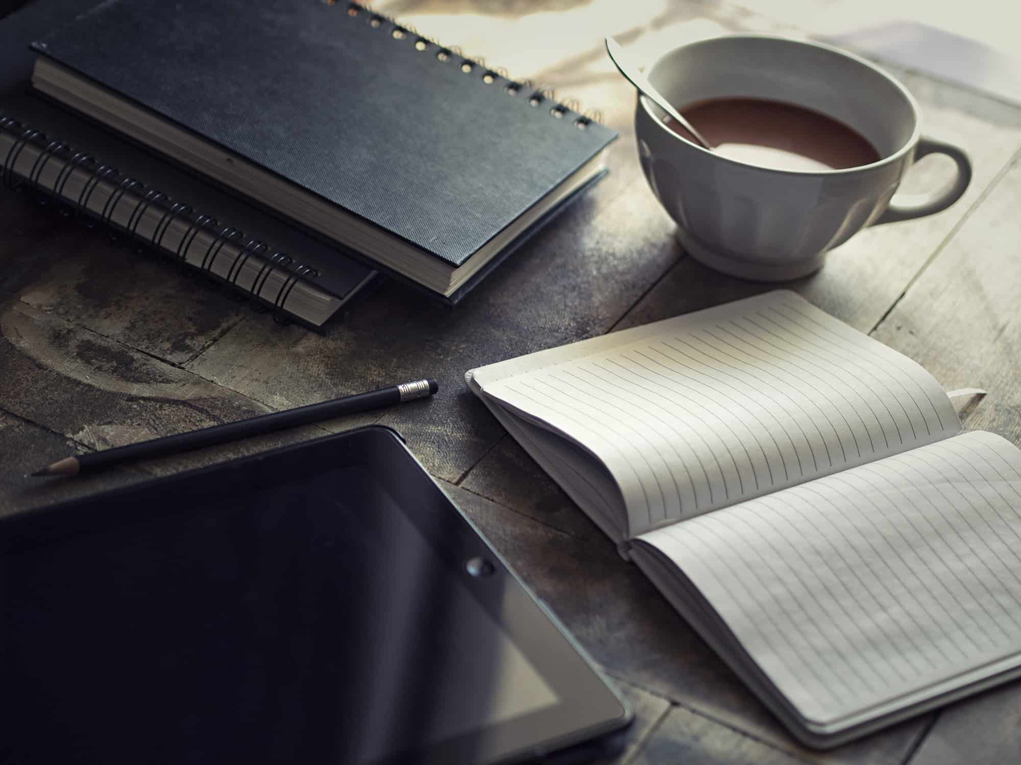 Notebook and coffee on a desk